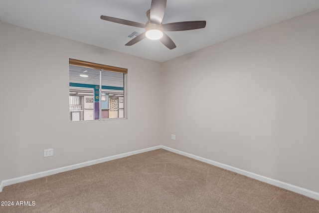 empty room with carpet flooring and ceiling fan