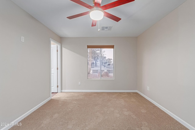 spare room with light carpet and ceiling fan