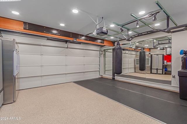 garage featuring stainless steel fridge and a garage door opener