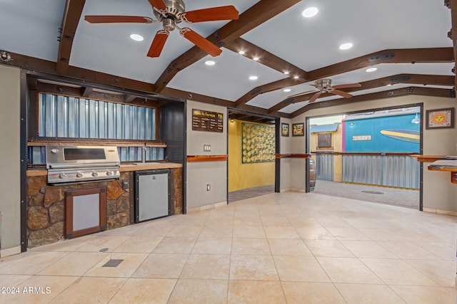 kitchen featuring lofted ceiling with beams, refrigerator, light tile patterned floors, and ceiling fan