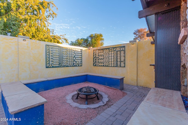 view of patio with a fire pit