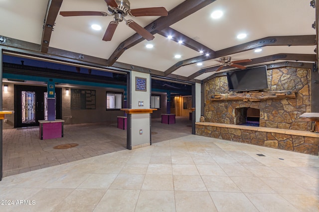 interior space featuring a kitchen bar, tile patterned floors, ceiling fan, and butcher block counters