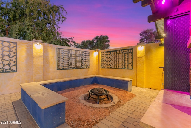 patio terrace at dusk with an outdoor fire pit