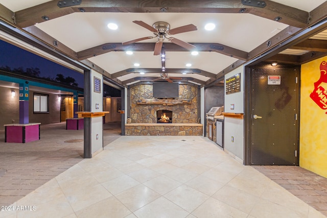 view of patio / terrace with area for grilling, ceiling fan, and a fireplace