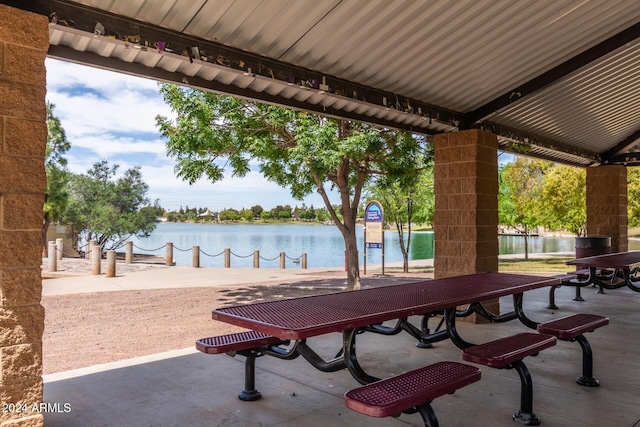 view of community with a patio and a water view