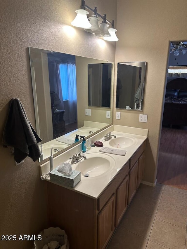 bathroom with tile patterned floors, double vanity, and a sink