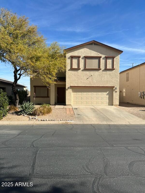 view of front of house featuring stucco siding, a garage, and concrete driveway