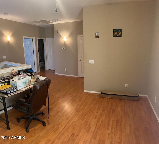 home office featuring visible vents, light wood-type flooring, and baseboards