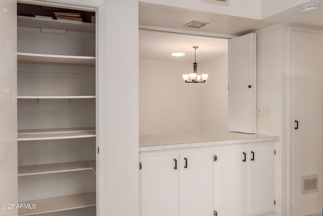 mudroom with a chandelier