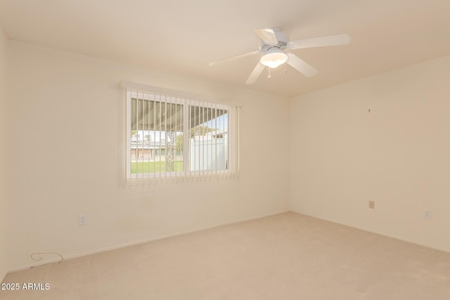 empty room featuring ceiling fan and carpet floors