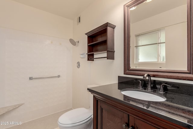 bathroom with a shower, vanity, and toilet