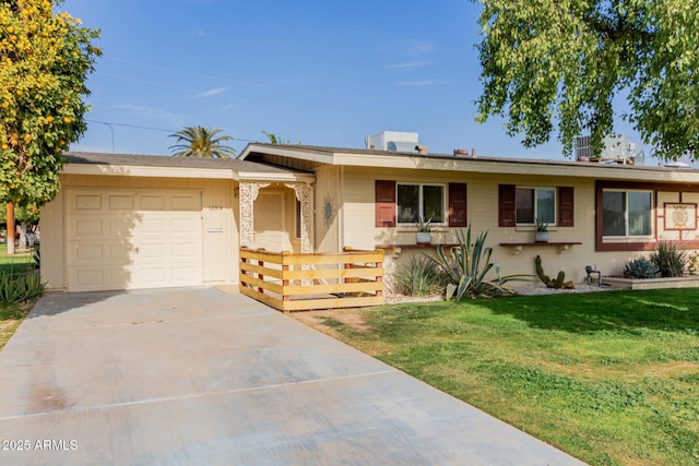 ranch-style house featuring covered porch, a front yard, and a garage