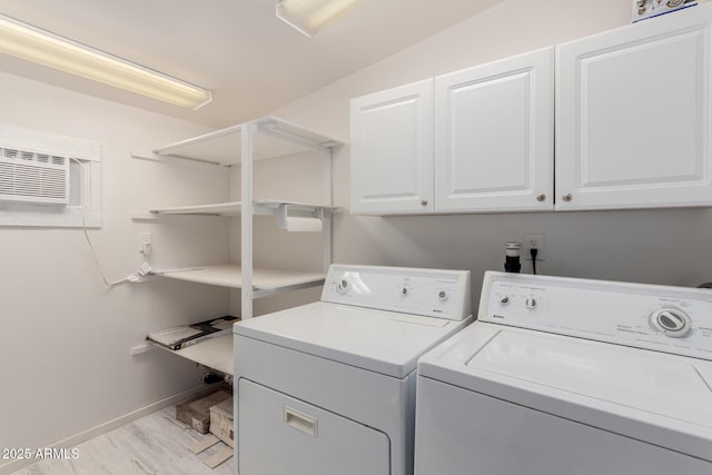 laundry area featuring cabinets, separate washer and dryer, and an AC wall unit