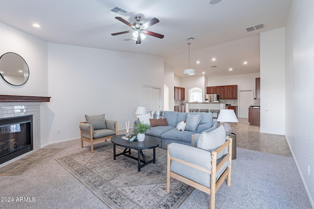 carpeted living room featuring ceiling fan