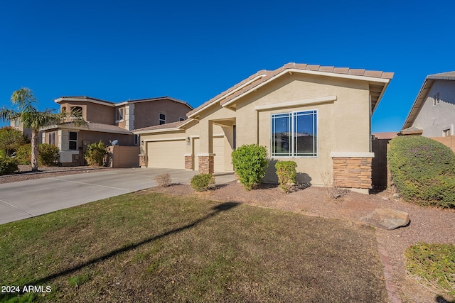 view of front of house with a garage and a front lawn