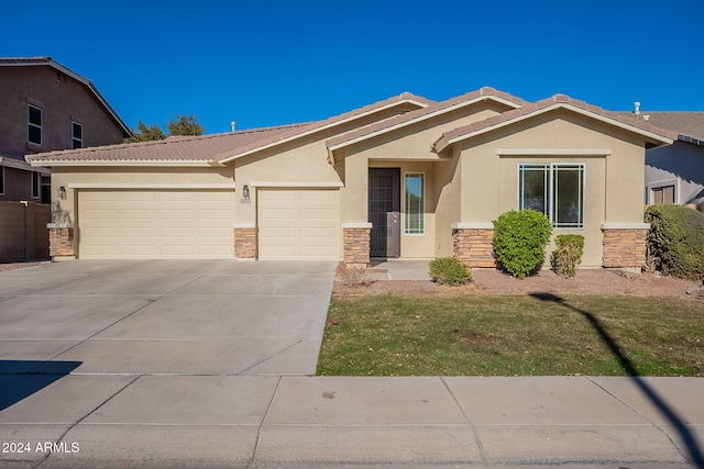 view of front of home with a front lawn and a garage