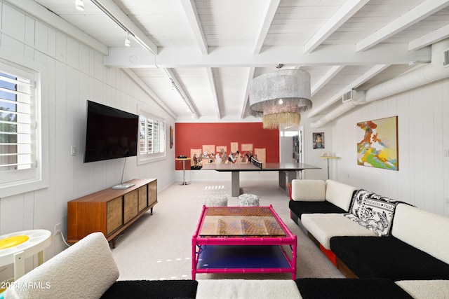 living room featuring light carpet, vaulted ceiling with beams, and wooden walls