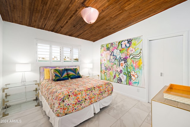 bedroom with lofted ceiling, wooden ceiling, and light tile patterned floors