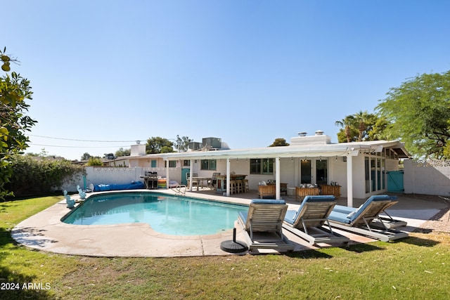 view of pool with a yard and a patio area