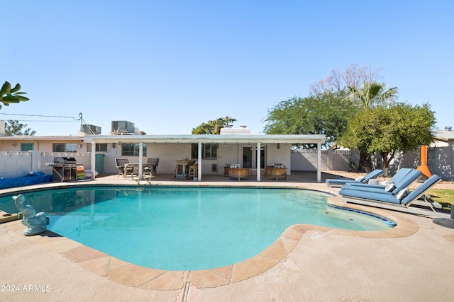 view of swimming pool with a patio and grilling area