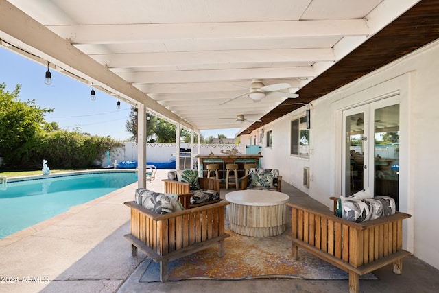 view of patio with a fenced in pool, french doors, and ceiling fan