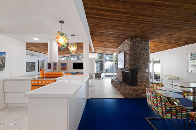 kitchen featuring lofted ceiling, wood ceiling, hanging light fixtures, and plenty of natural light