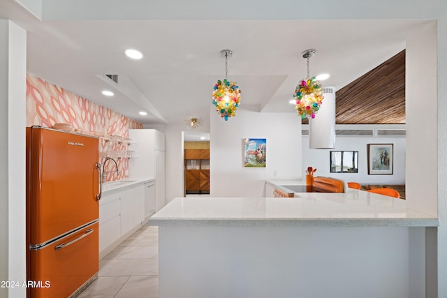 kitchen featuring hanging light fixtures, kitchen peninsula, stainless steel fridge, light tile patterned flooring, and white cabinets