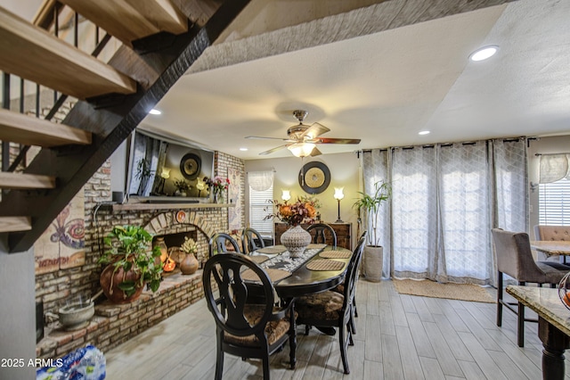 4112 E Maldonado Dr, Phoenix, AZ 85042 - dining space featuring recessed lighting, a brick fireplace, a ceiling fan, and wood finished floors