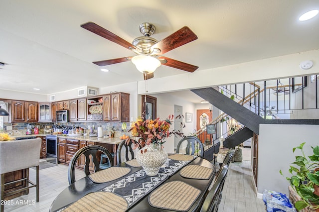 4112 E Maldonado Dr, Phoenix, AZ 85042 - dining area featuring light wood-style flooring, stairway, ceiling fan, and recessed lighting