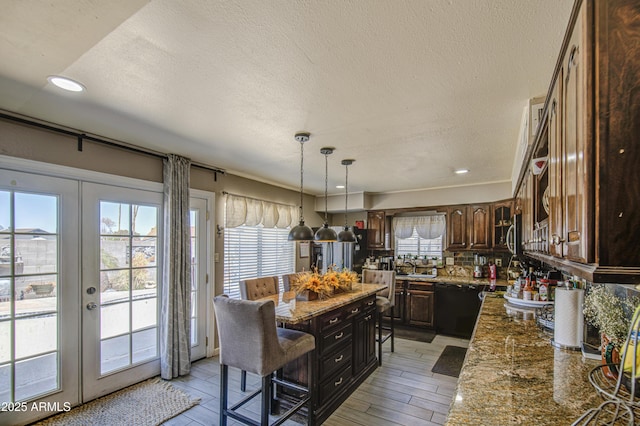 4112 E Maldonado Dr, Phoenix, AZ 85042 - kitchen featuring a textured ceiling, stone countertops, dishwasher, french doors, and decorative backsplash