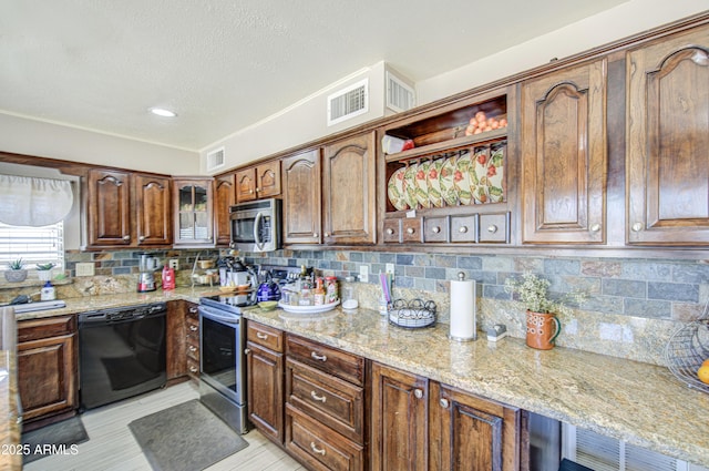4112 E Maldonado Dr, Phoenix, AZ 85042 - kitchen with tasteful backsplash, light stone counters, visible vents, and stainless steel appliances