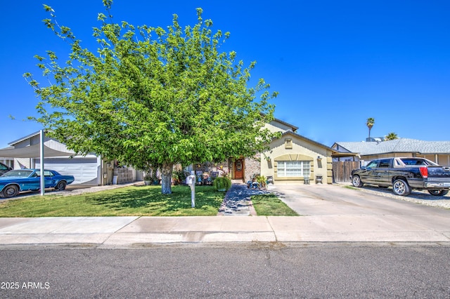 4112 E Maldonado Dr, Phoenix, AZ 85042 - obstructed view of property with concrete driveway, fence, and a front lawn