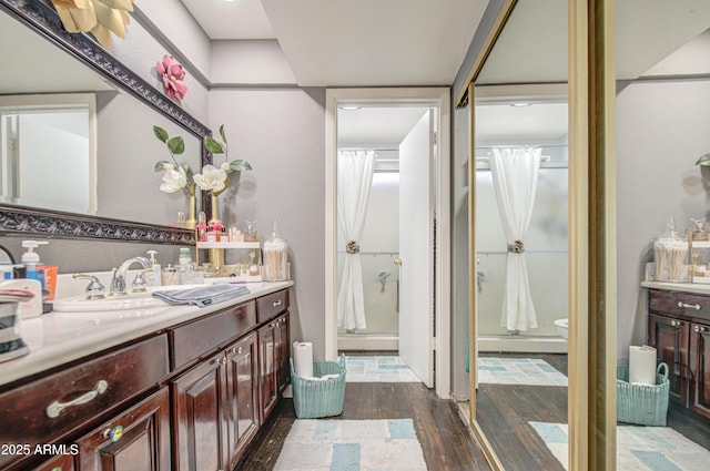 4112 E Maldonado Dr, Phoenix, AZ 85042 - bathroom with toilet, a textured wall, hardwood / wood-style flooring, a shower stall, and vanity
