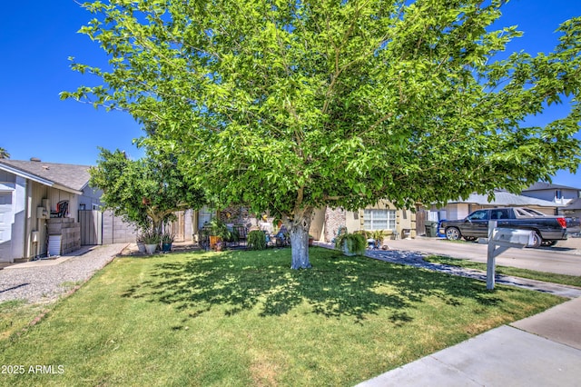 4112 E Maldonado Dr, Phoenix, AZ 85042 - view of property hidden behind natural elements featuring concrete driveway, a front yard, and fence