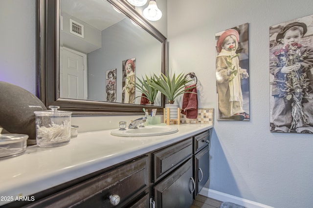 4112 E Maldonado Dr, Phoenix, AZ 85042 - bathroom with visible vents, baseboards, and vanity