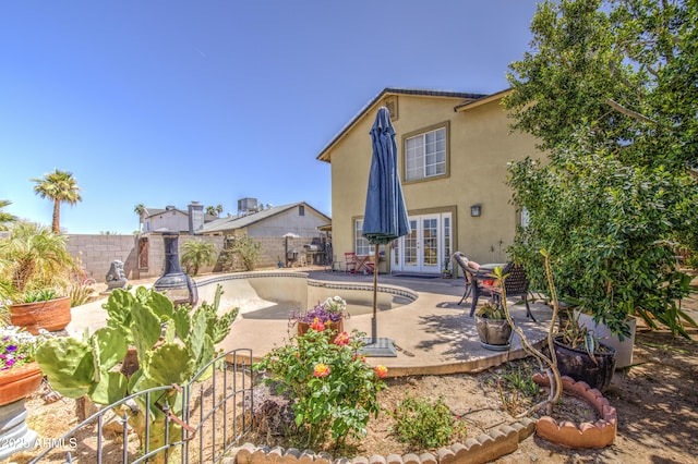 4112 E Maldonado Dr, Phoenix, AZ 85042 - back of property with a fenced in pool, a patio, stucco siding, french doors, and a fenced backyard