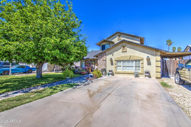 4112 E Maldonado Dr, Phoenix, AZ 85042 - view of front facade featuring driveway, stucco siding, and a front lawn