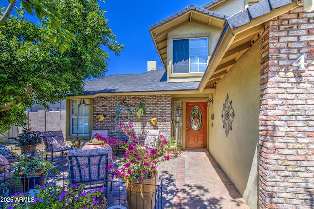 4112 E Maldonado Dr, Phoenix, AZ 85042 - view of exterior entry with a patio, brick siding, stucco siding, and fence