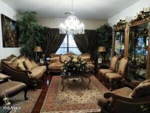 living room featuring wood finished floors and a notable chandelier