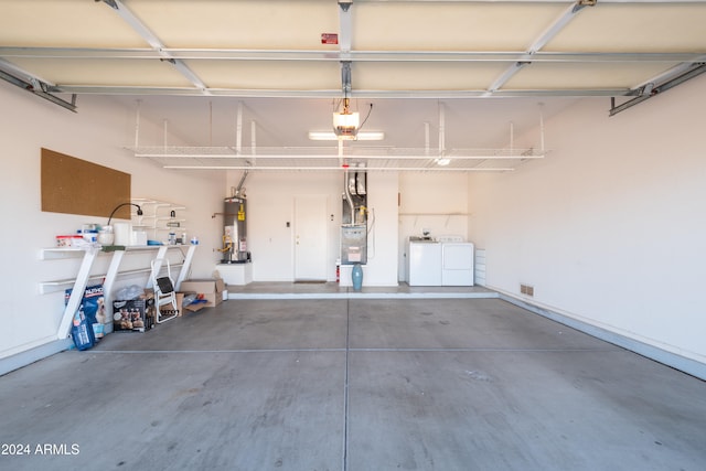 garage featuring washer and clothes dryer and gas water heater