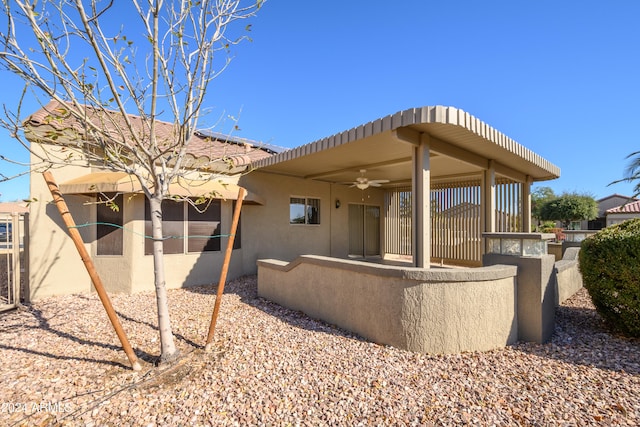 back of property featuring ceiling fan