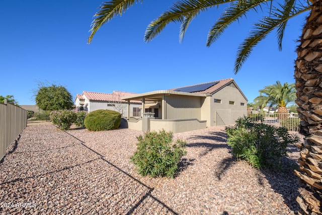 view of home's exterior featuring solar panels