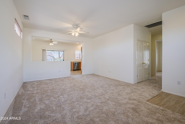 unfurnished living room with ceiling fan and light carpet