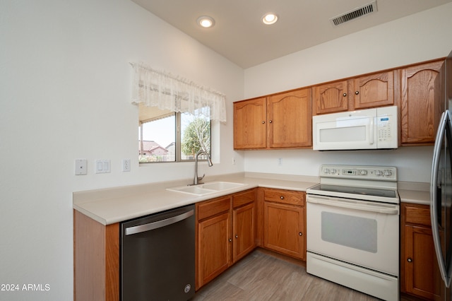 kitchen featuring white appliances and sink