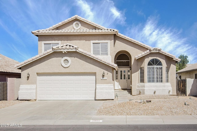 2806 E Pontiac Dr, Phoenix, AZ 85050 - mediterranean / spanish house with a tiled roof, stucco siding, a garage, and concrete driveway