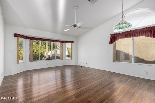 spare room with ceiling fan, dark wood-type flooring, and vaulted ceiling