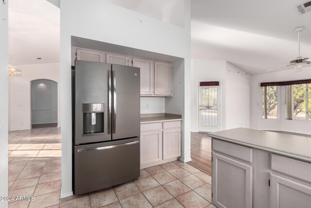 kitchen with stainless steel fridge, light hardwood / wood-style floors, ceiling fan, and lofted ceiling