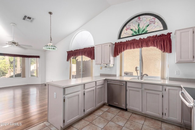 kitchen featuring lofted ceiling, sink, ceiling fan, decorative light fixtures, and stainless steel appliances