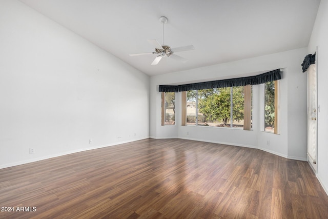 unfurnished room with dark hardwood / wood-style floors, vaulted ceiling, and ceiling fan