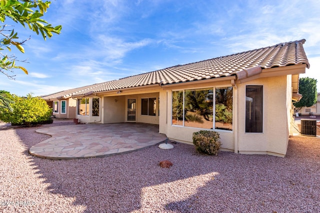 back of property with a patio and central AC unit